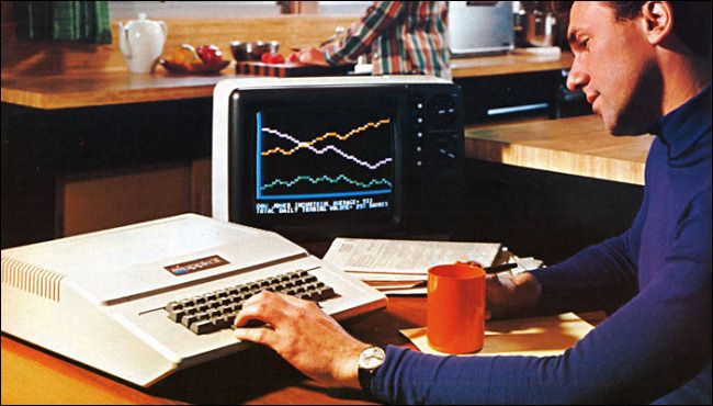 Old photo of man creating charts and graphs on his Apple Two computer Old photo of man creating charts and graphs on his Apple Two computer