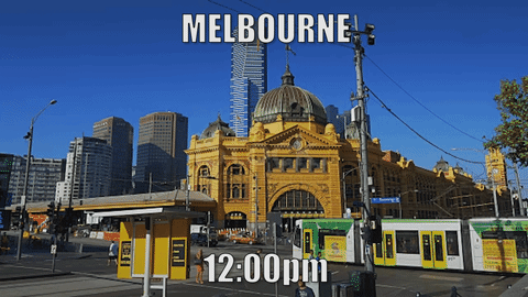 A tram runs past Flinders street in sunny weather, half an hour later it’s raining. A tram runs past Flinders street in sunny weather, half an hour later it’s raining.