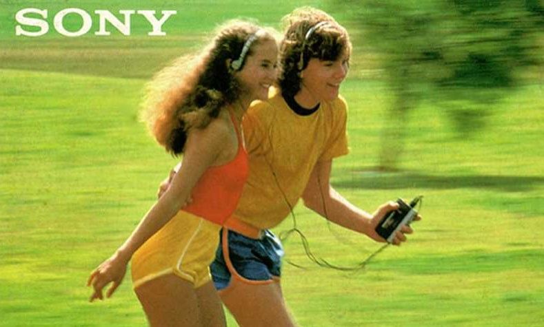 A man and woman listening to a Walkman while rollerskating. A man and woman listening to a Walkman while rollerskating.