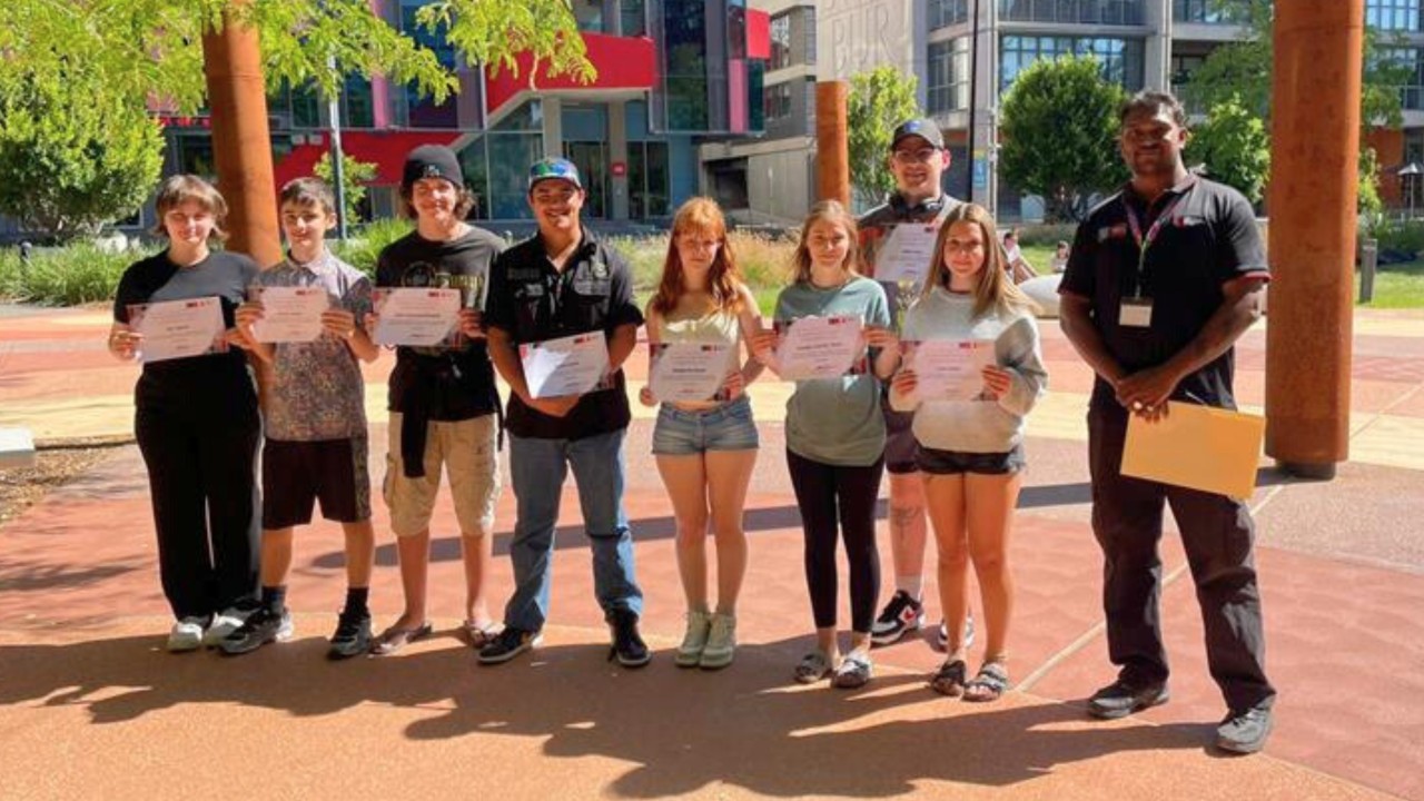 MTC-FAC attendees receiving their camp completion certificates at the family gathering event at the Indigenous Learning Circles at Swinburne's Hawthorn campus. MTC-FAC attendees receiving their camp completion certificates at the family gathering event at the Indigenous Learning Circles at Swinburne's Hawthorn campus.