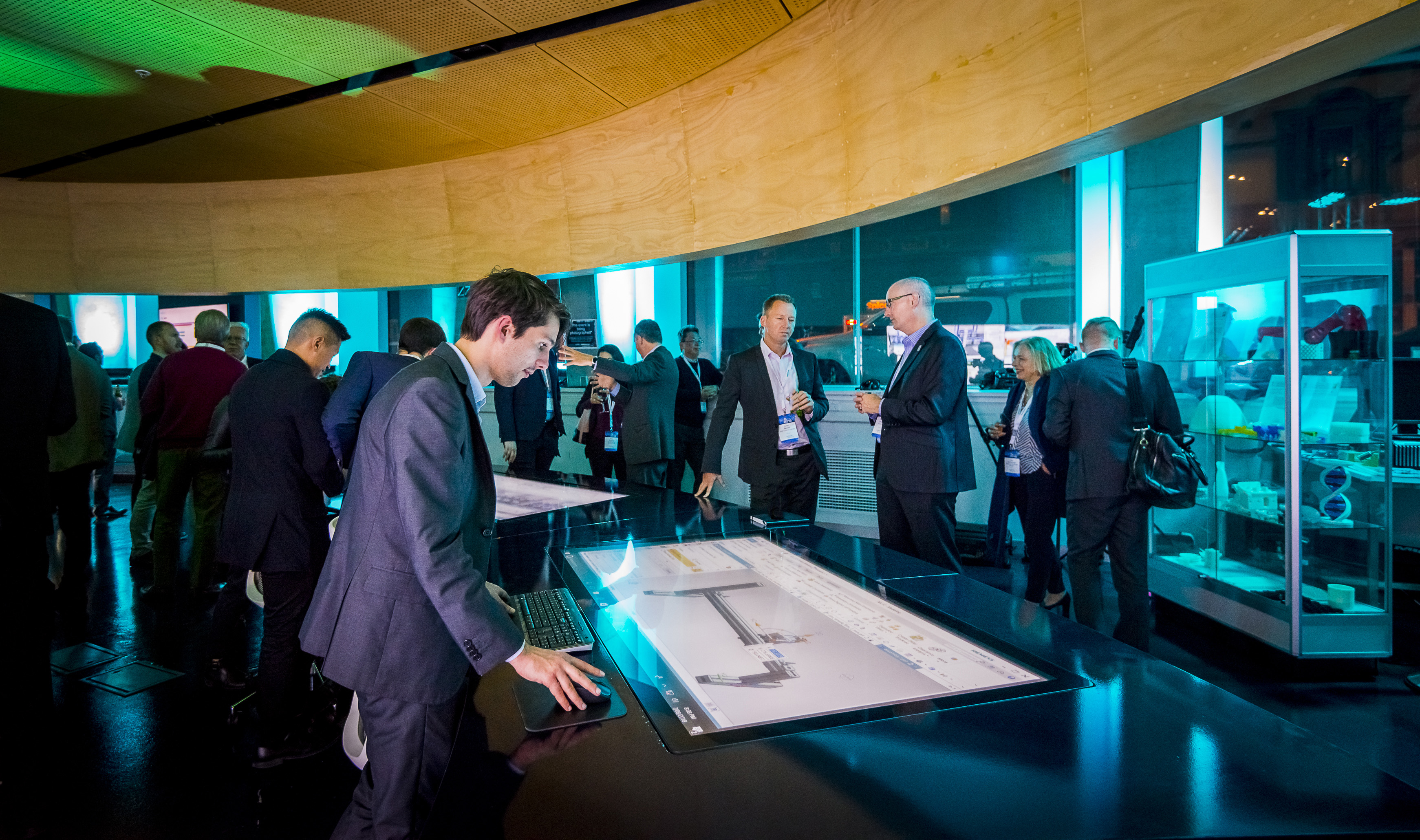 Swinburne graduate Callan Halton, operating a touch screen showing a Siemens factory simulation at the MindSphere launch event