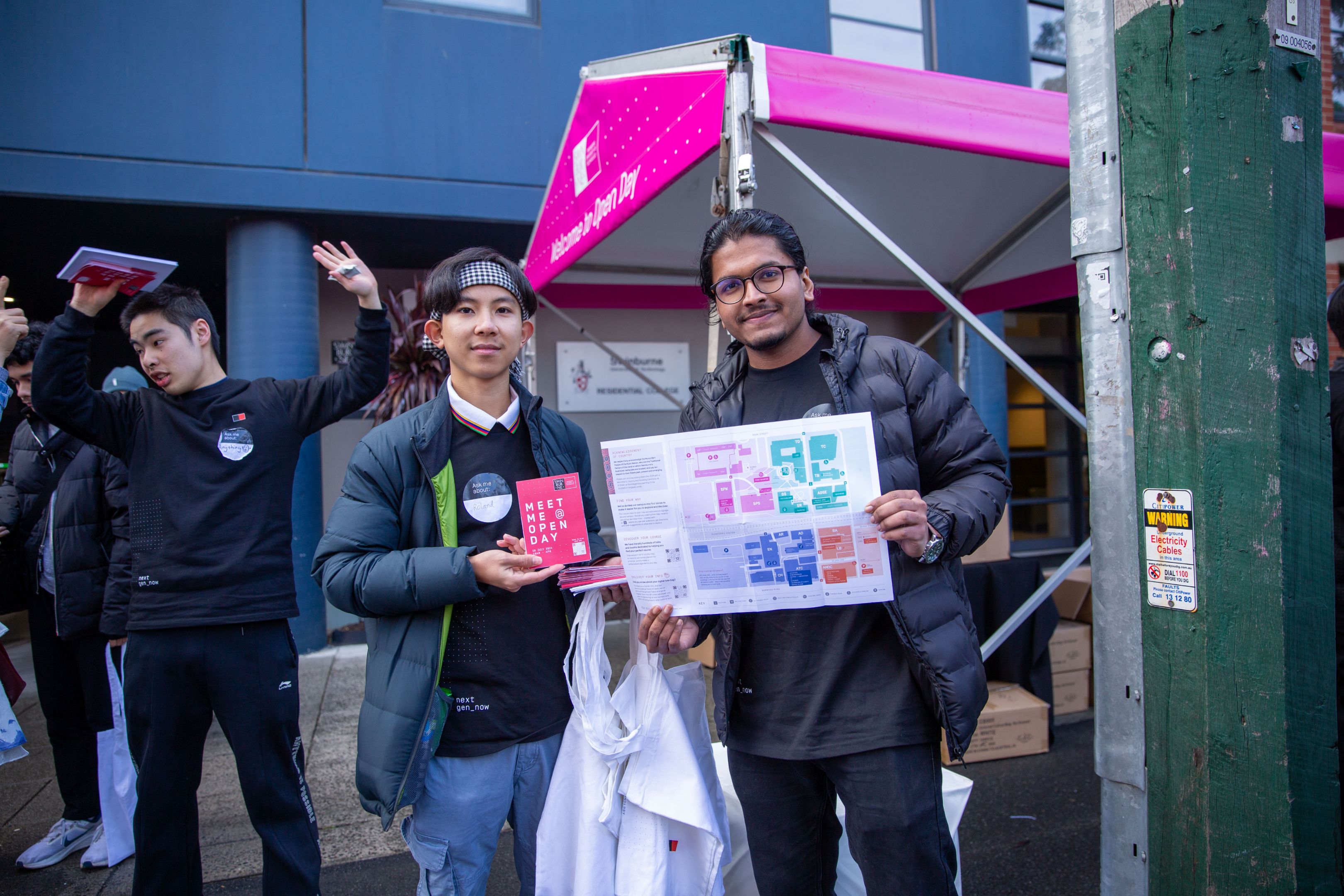 Open Day 2024 Two Open Day volunteers hold a colour-coded map of Swinburne’s Hawthorn campus