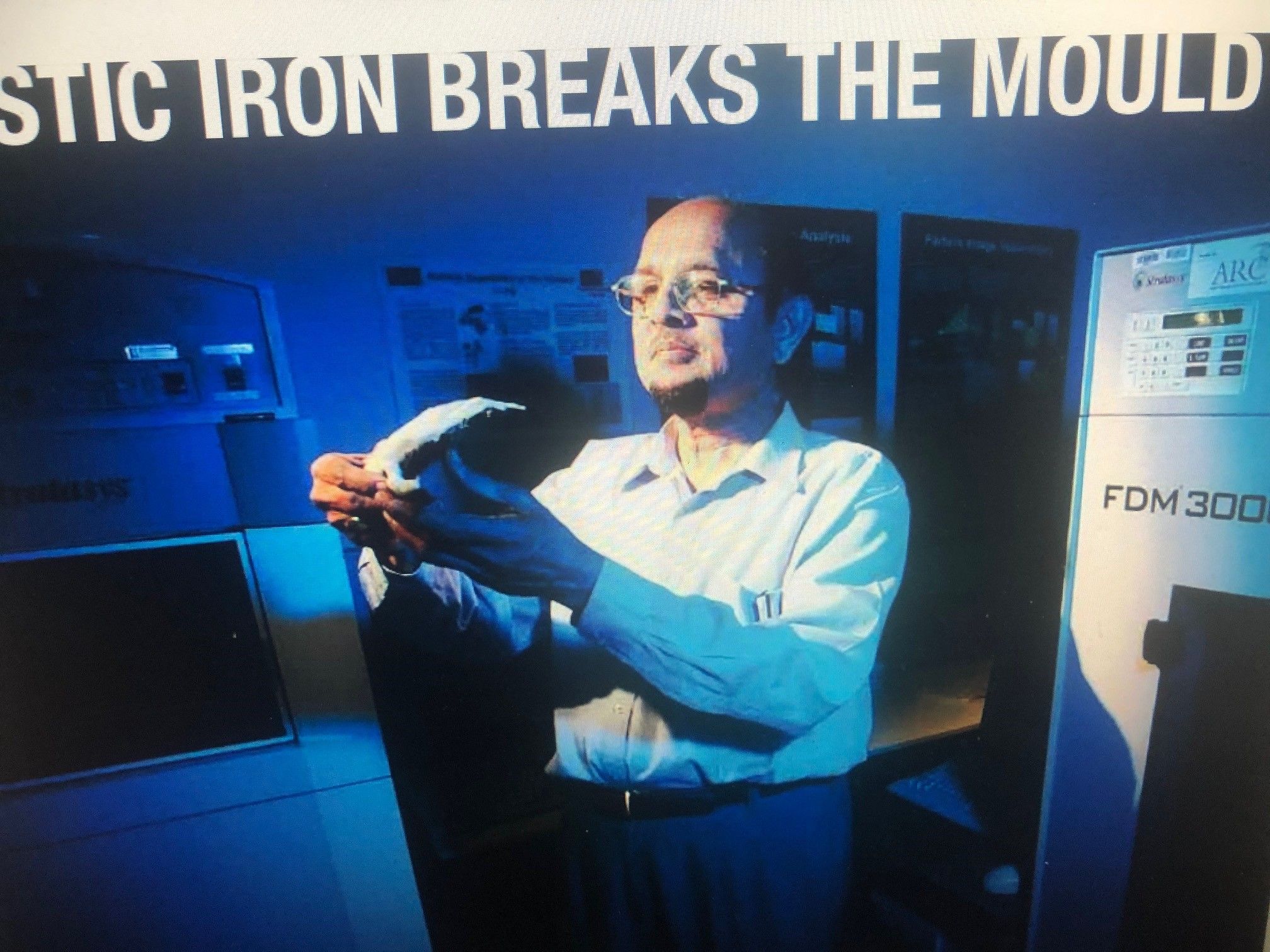 Professor Masood pictured in the news with a FDM 3D printer Professor Masood holds a model that has been 3D printed from a FDM printer which stands behind him on the right