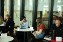 A student sitting talking to a teacher at the COP expo