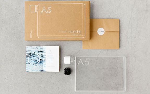 A person holds a memobottle close to thier chest