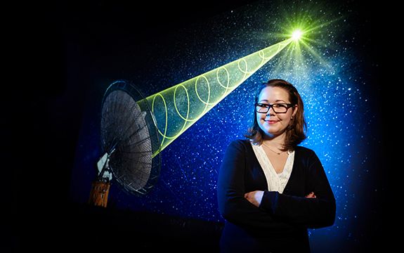 A photograph of Emily Petroff Emily Petroff has been superimposed on to an image of a satellite beaming a green signal into the stars