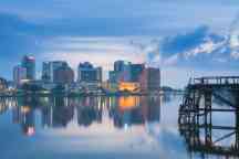 A city on the water with a jetty in the foreground