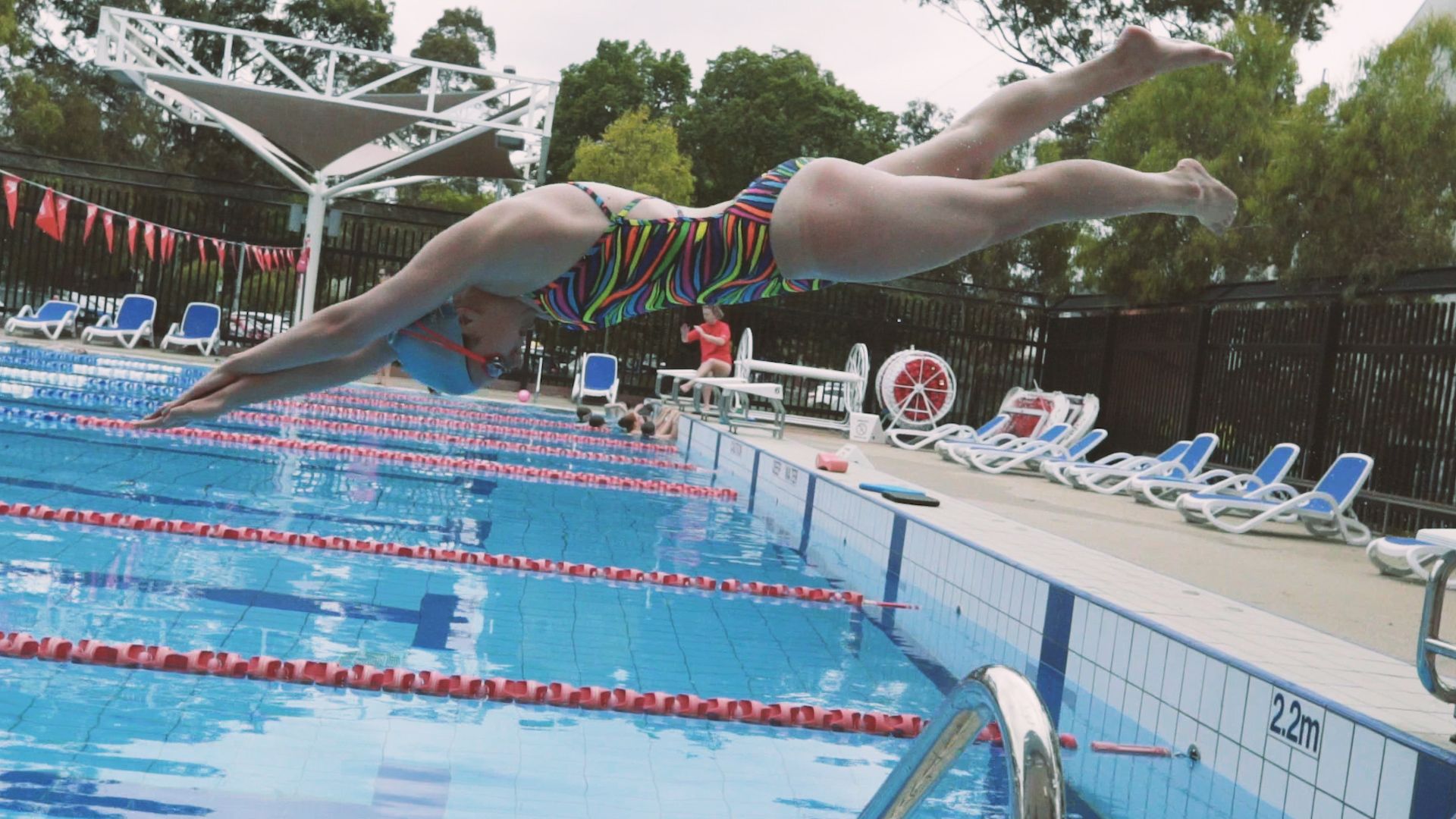 Swimming pool Female student dives into a pool at the open air Hawthorn Aquatic Centre