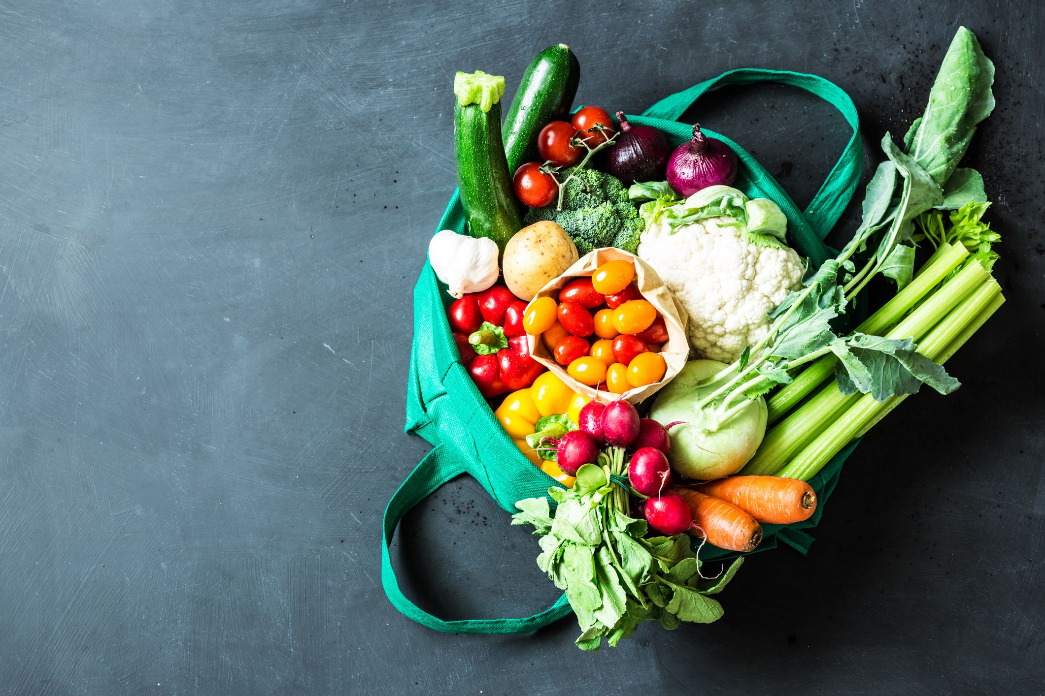Colorful organic vegetables in green eco shopping bag. Colorful organic vegetables in green eco shopping bag