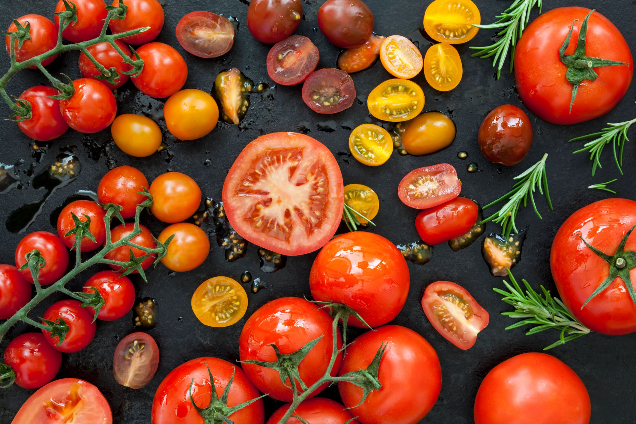 Tomato varieties on black iron. Tomato Varieties on Black Overhead View
