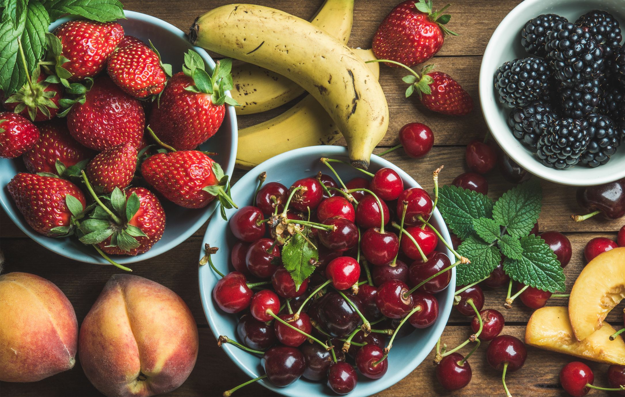 Summer fresh fruit and berry variety over wooden backdrop. Summer fresh fruit and berry variety over wooden backdrop