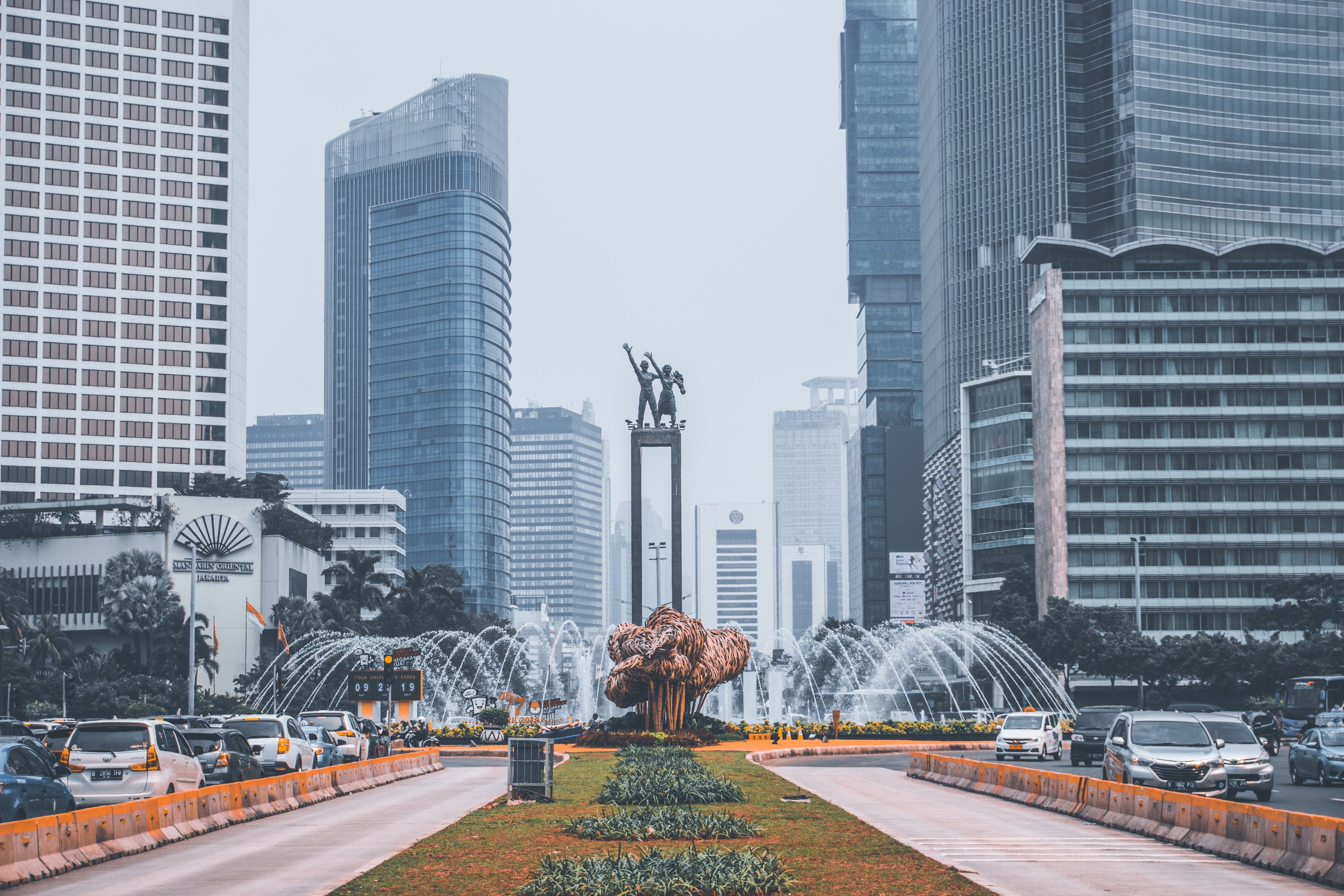 Indonesian Skyscrapers in Jakarta fountain in foreground framed either side and behind by skyscrapers in Jakarta, Indonesia