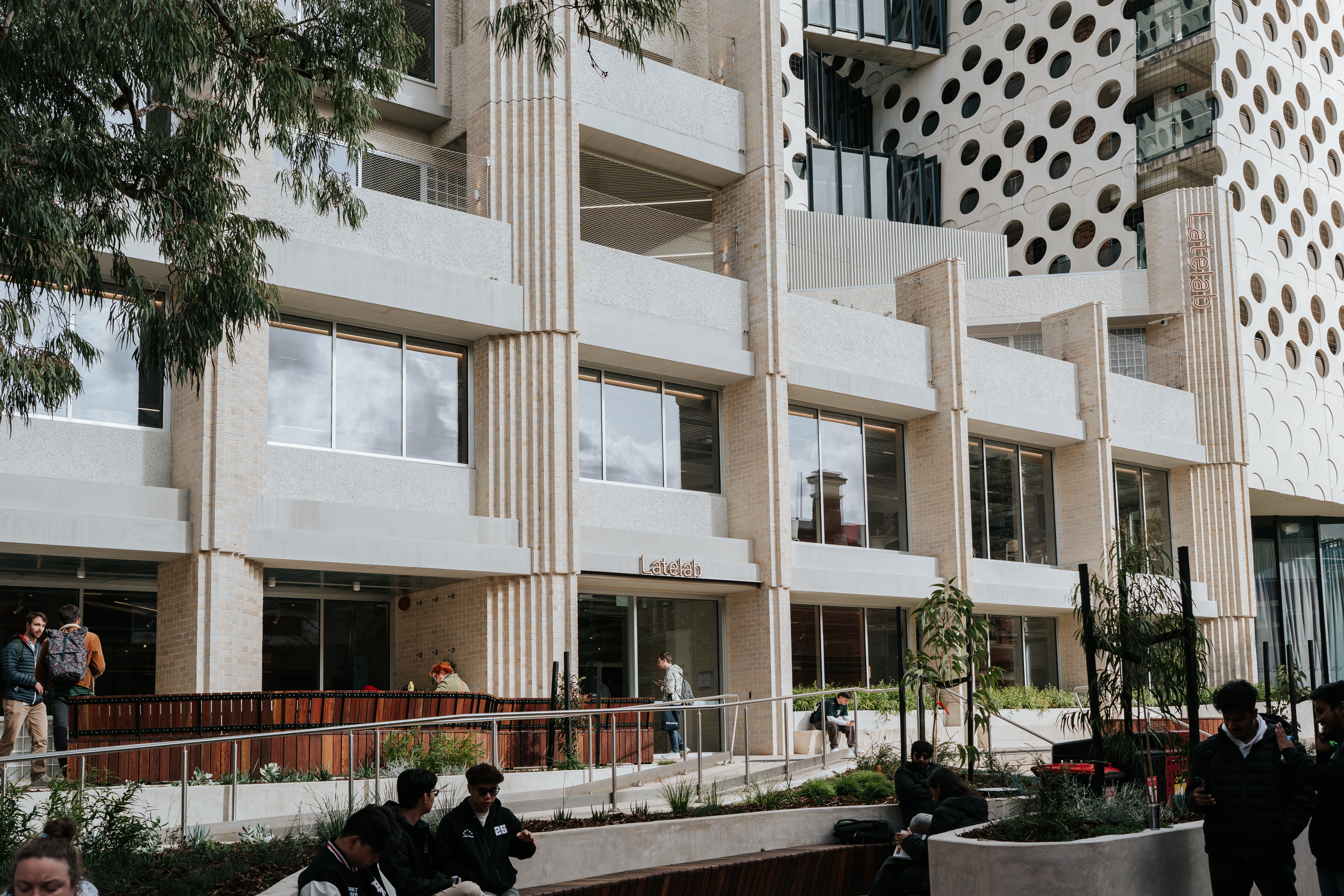 Students walking by the new architecturally designed Latelab building