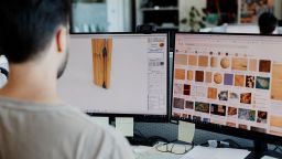 A designer comparing various textures of wood to apply to his prototype.