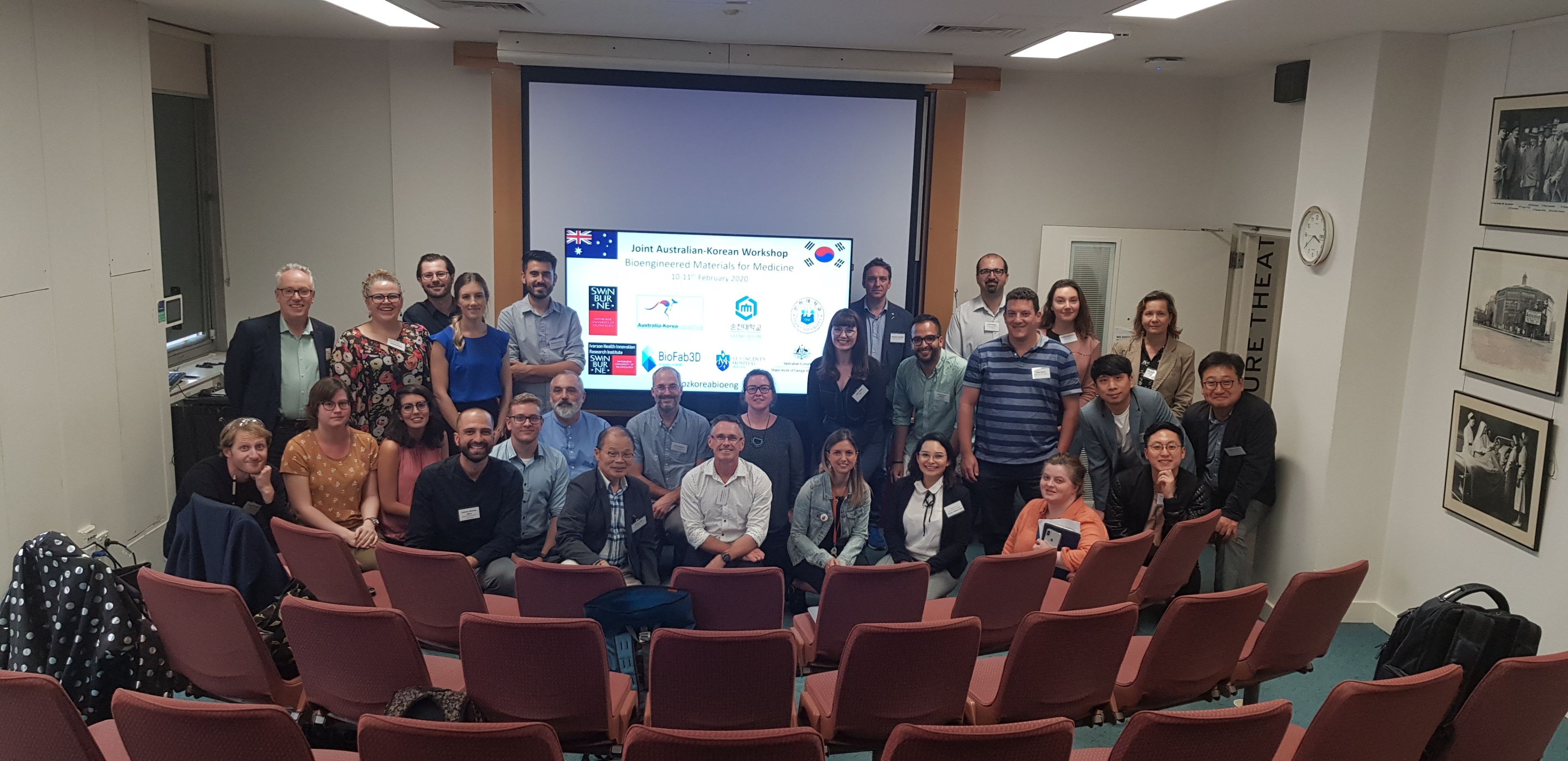 Australia-Korea Bioengineering Workshop, February 2020 Large group of smiling people standing in a room in front of a presentation screen.
