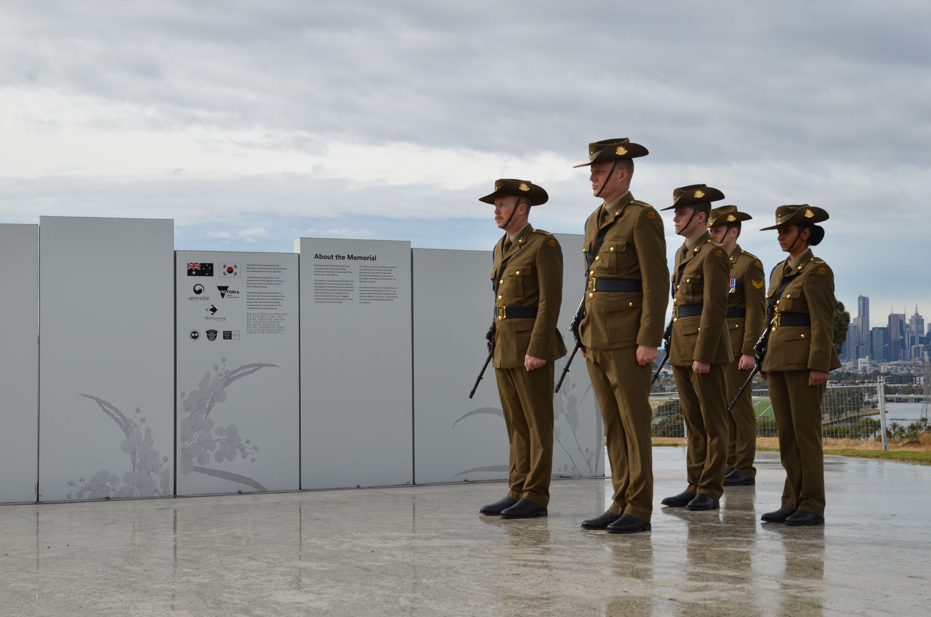 Soldiers attend the unveiling to honour those who served in the War. Soldiers standing in front of the Melbourne Korean War Memorial