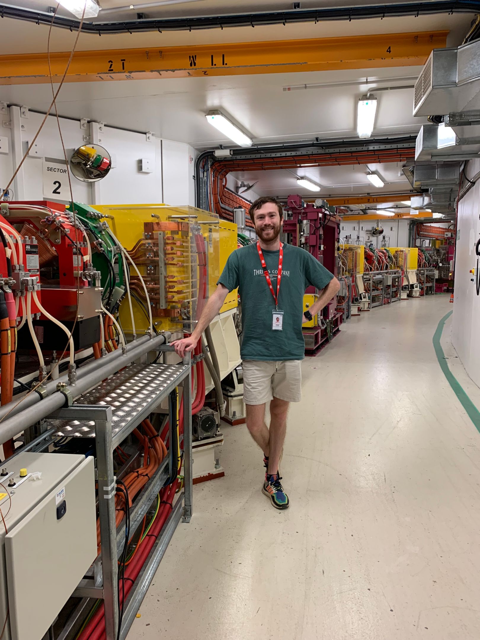 Matt Large at ANSTO's Australian Synchrotron Post-Doctoral Research Fellow at Swinburne's Space Technology and Industry Institute, Matt Large, stands in front of complex machinery at ANSTO's Australian Synchrotron in Melbourne.
