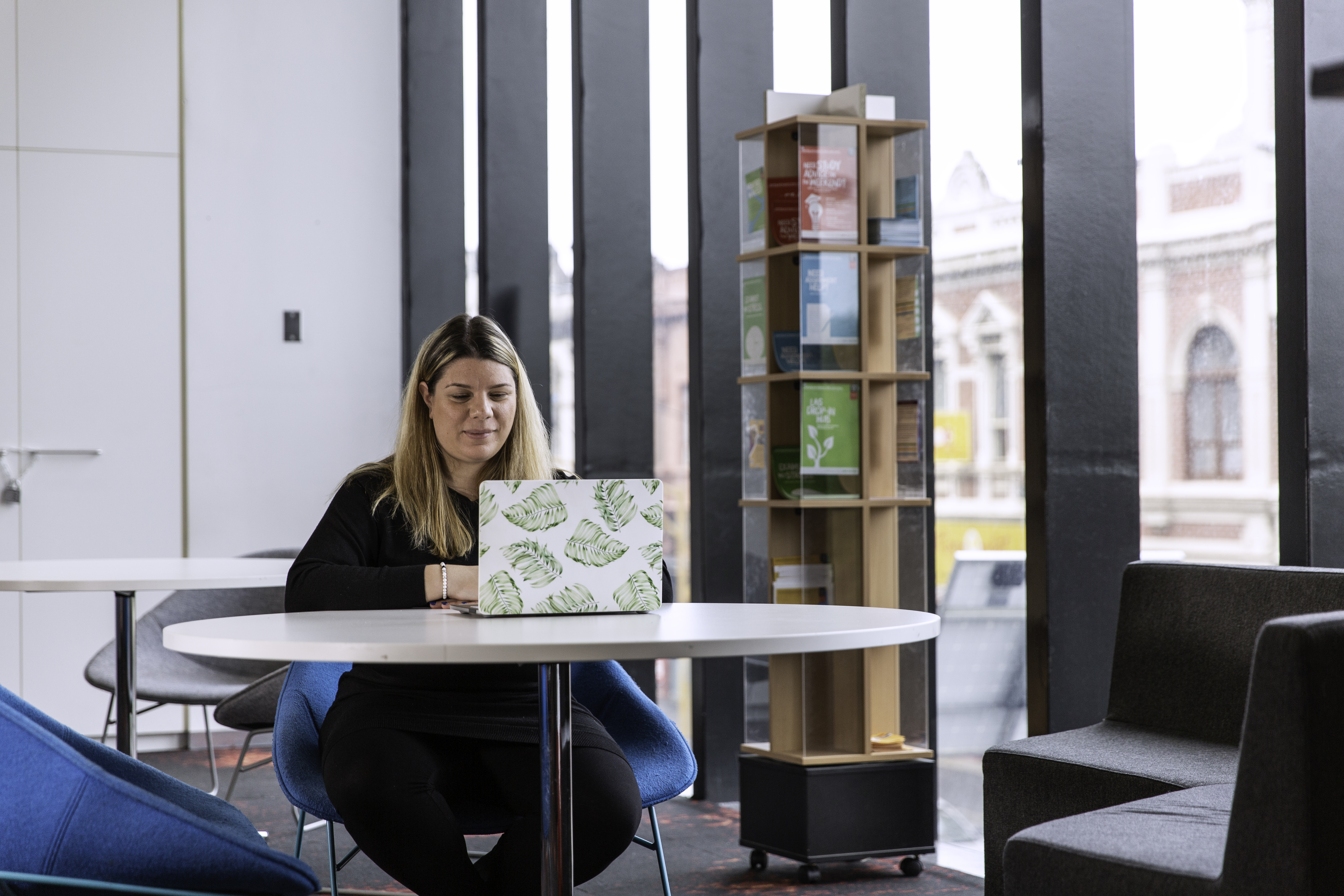Woman working on a laptop A Blonde woman wearing black, works at a laptop at one of Swinburne's various study spaces