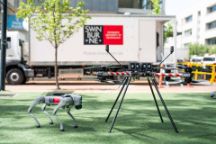 A robot dog and a drone outside the Mobile Innovation Lab.