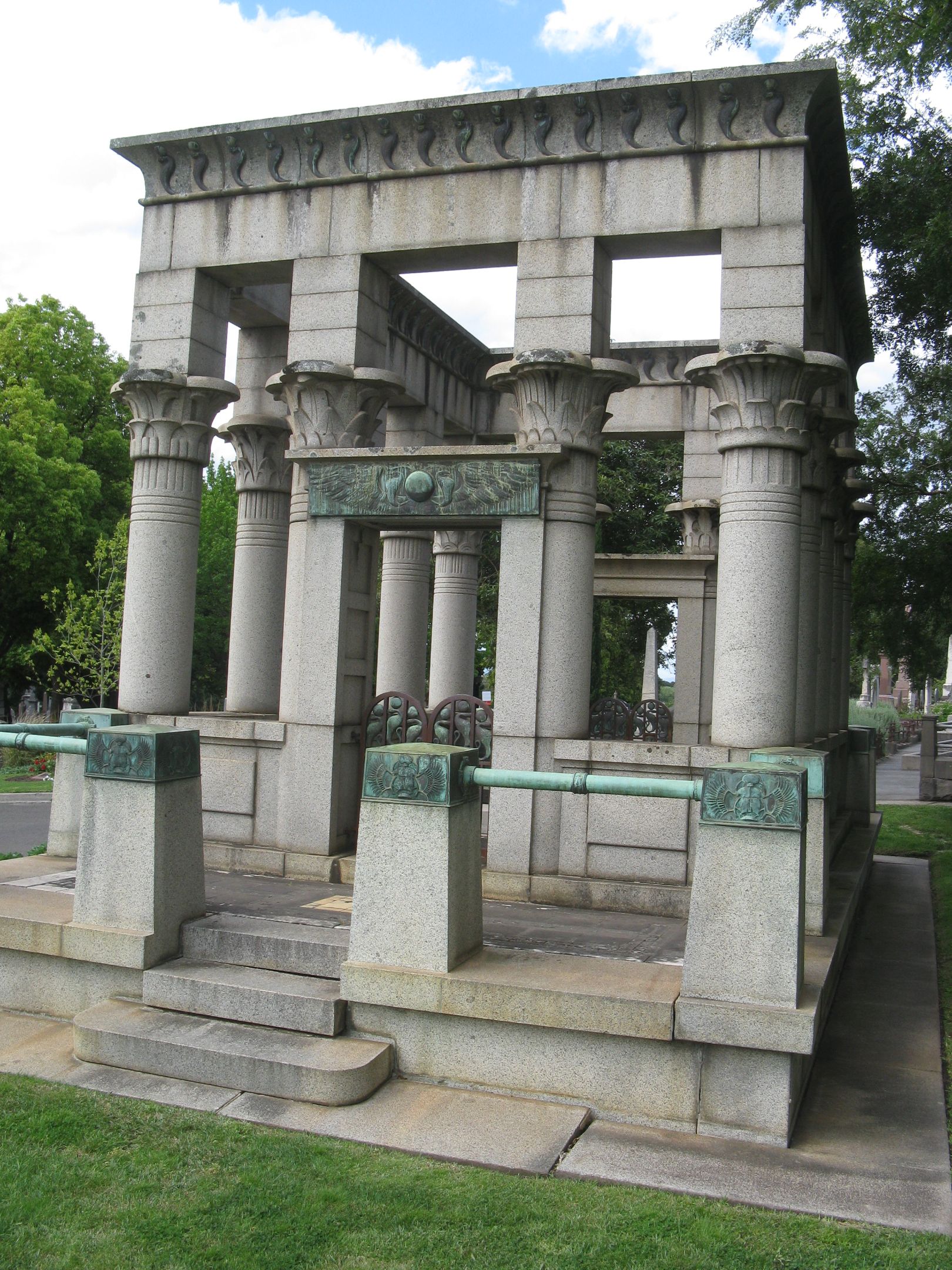 Syme Memorial A memorial made out of multiple stone or granite columns, sitting in a cemetary.