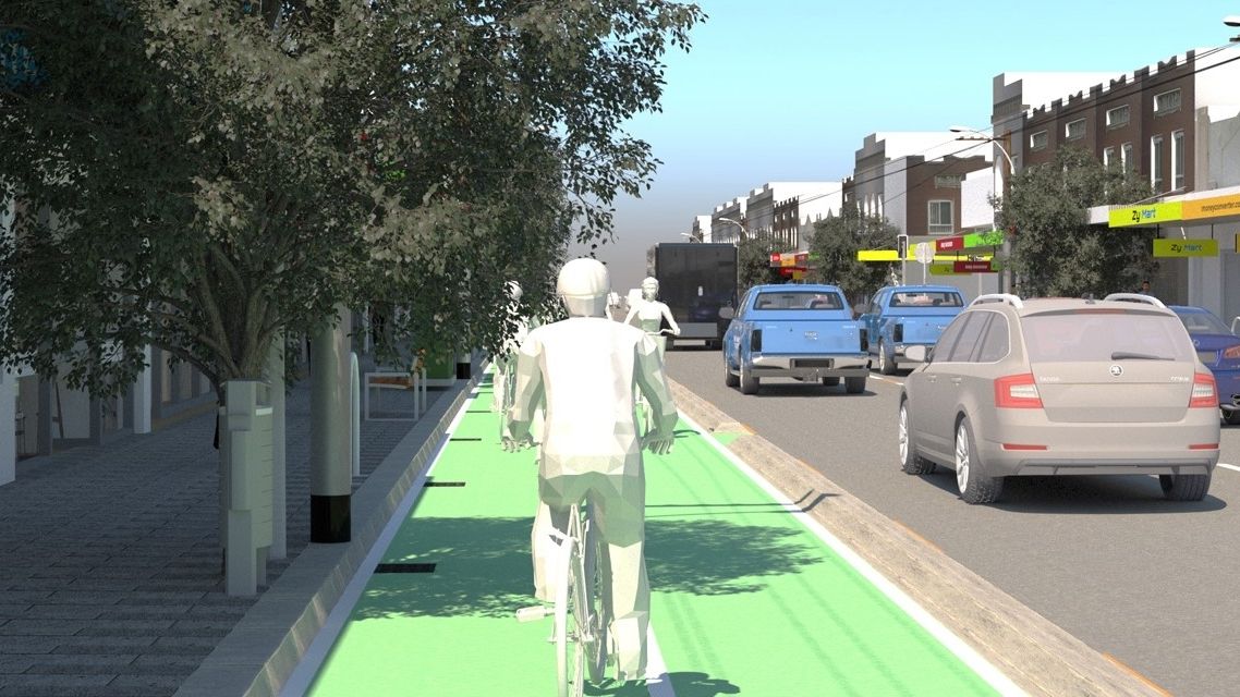 Smart Cities, Future Spaces for Living, VR simulation 1 Presented as a virtual reality simulation, an animated figure is riding a bicycle in a bike lane on a city street, with cars driving past.