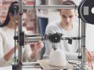Academic students using a 3D printer in the lab