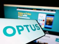 Stuttgart, Germany - 07-03-2022: Smartphone with logo of communications company SingTel Optus Pty. Ltd. on screen in front of website. Focus on center-left of phone display.