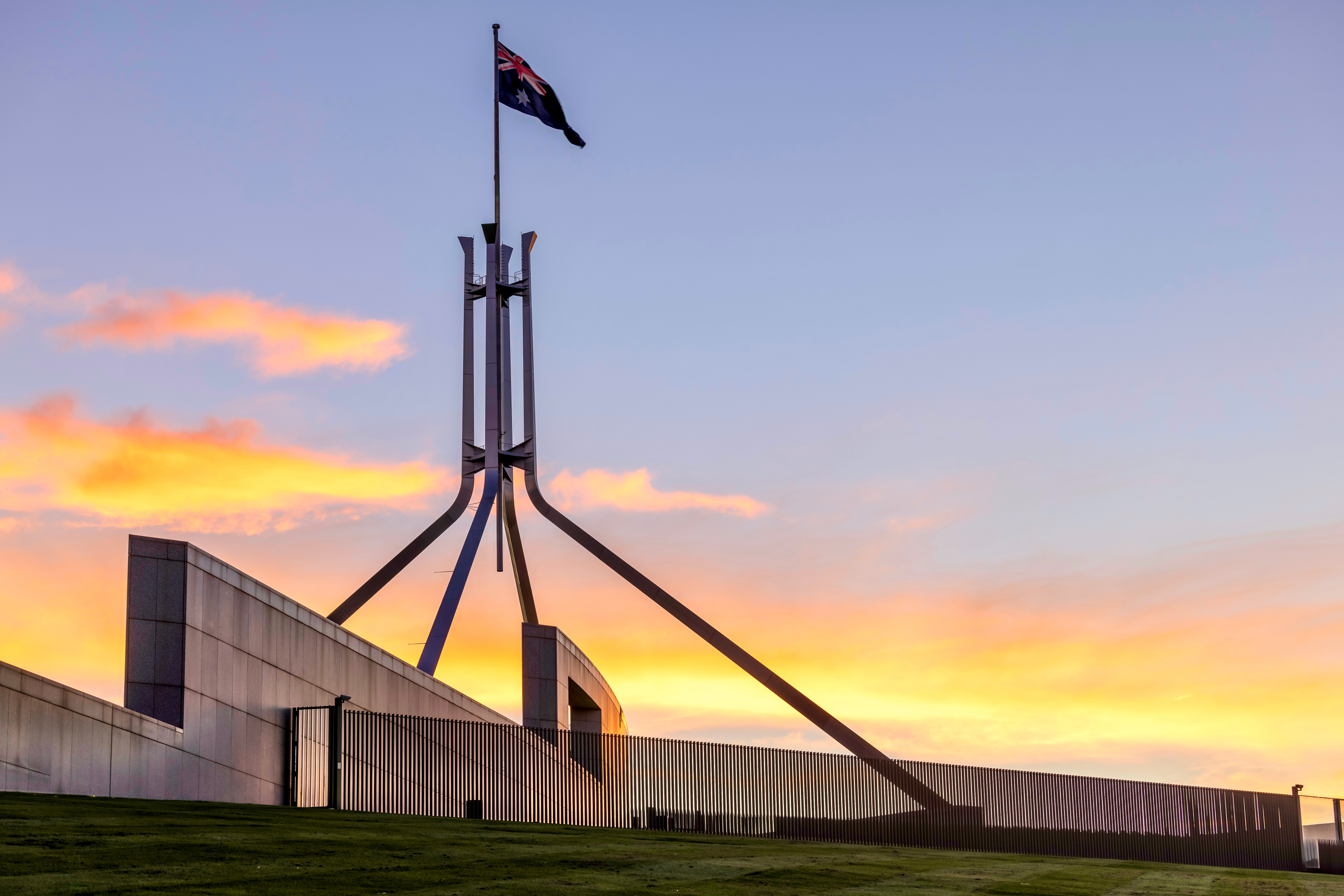 Australian Parliament House Canberra Australian Capital Territory. Showing the roof at sunset and the Australian Flag