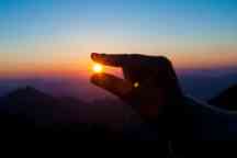 Hand gripping the sun