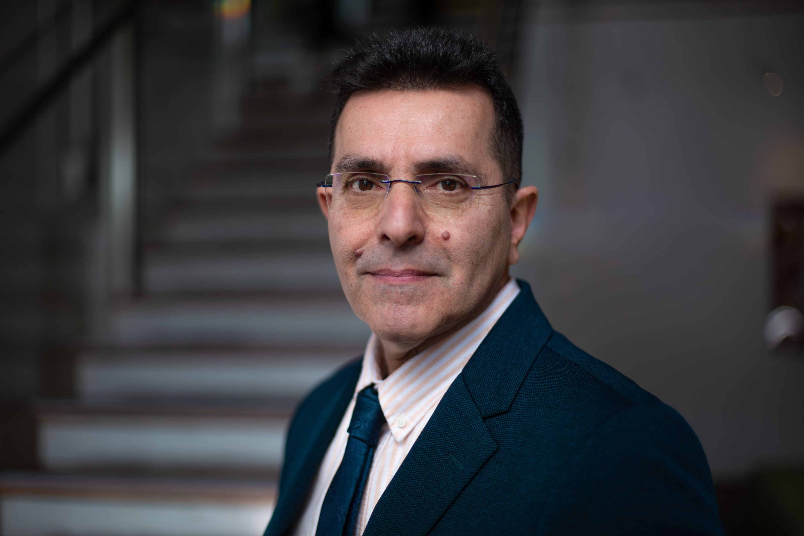 Saeid Nahavandi Man with glasses in a suit standing slightly side on looking at the camera.