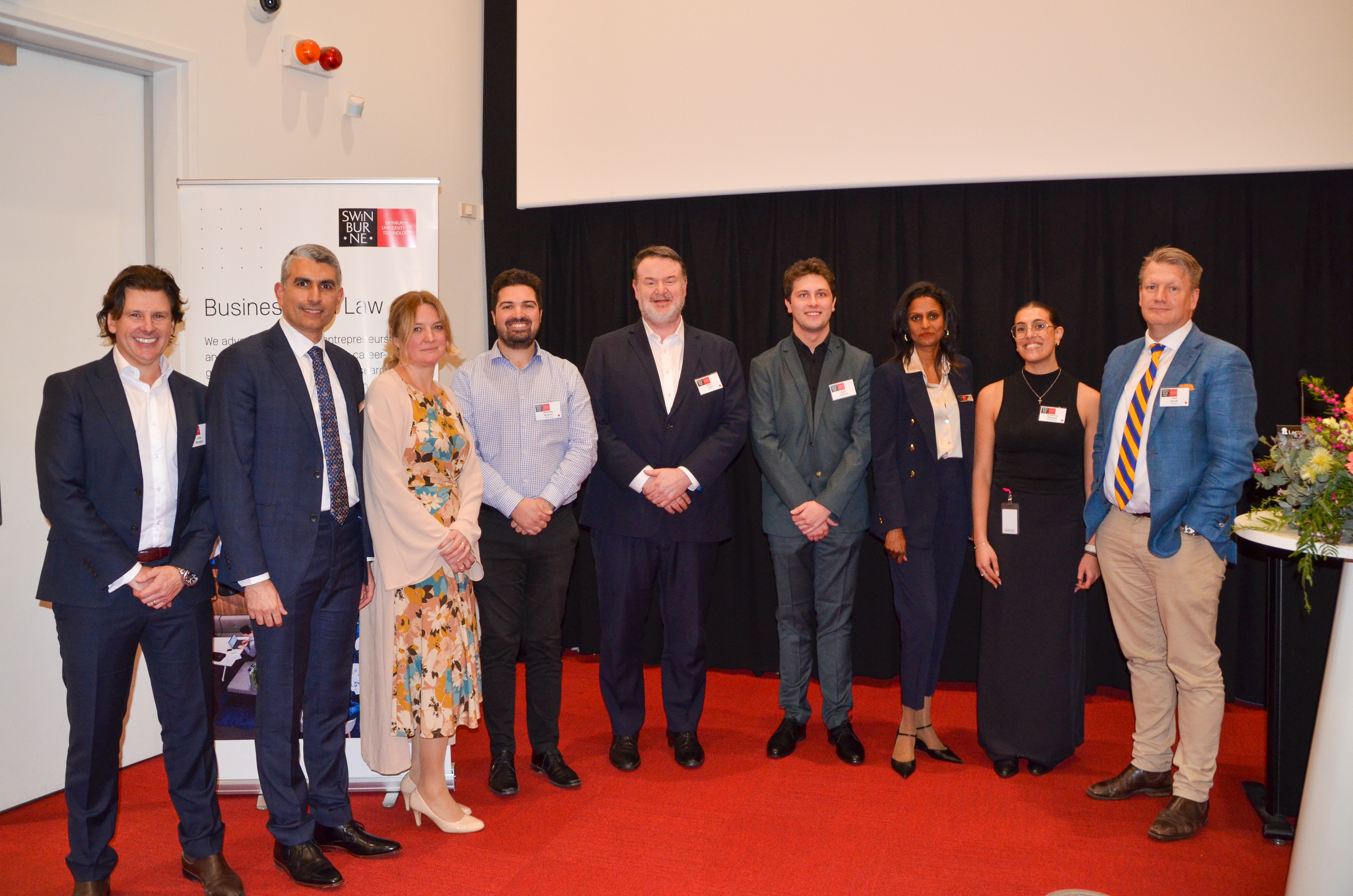 group of finance and accounting experts pose together for a photo in a lecture theatre
