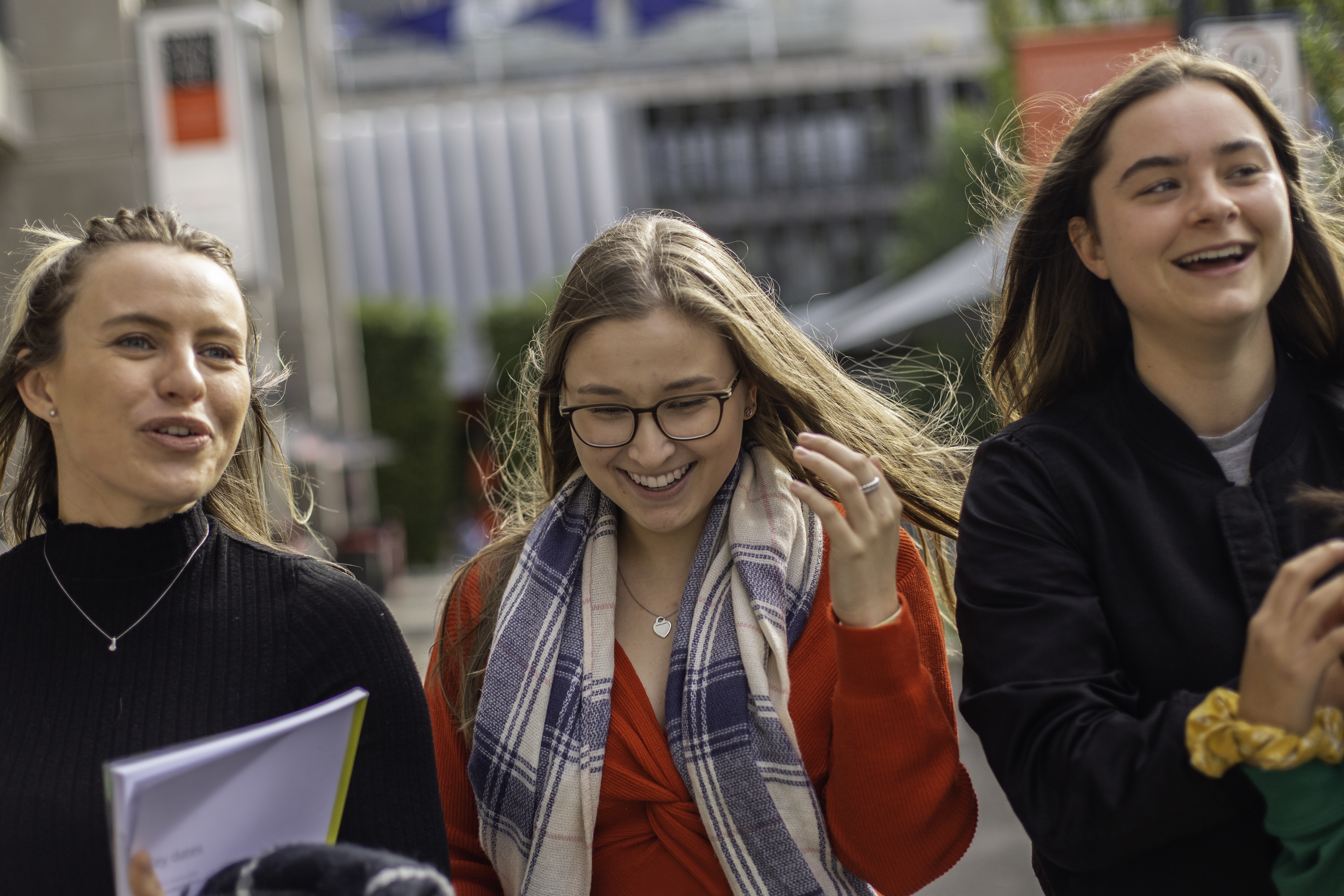 Three female students walking Three female students chatting as they walk around the Hawthorn campus