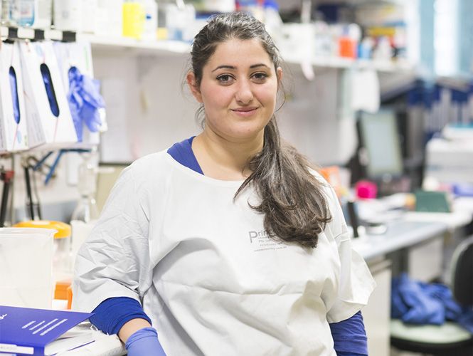 Who knows where your real industry experience could take you. A Swinburne pharmacy placement student wearing a white lab coat and blue gloves, smiles for the camera.