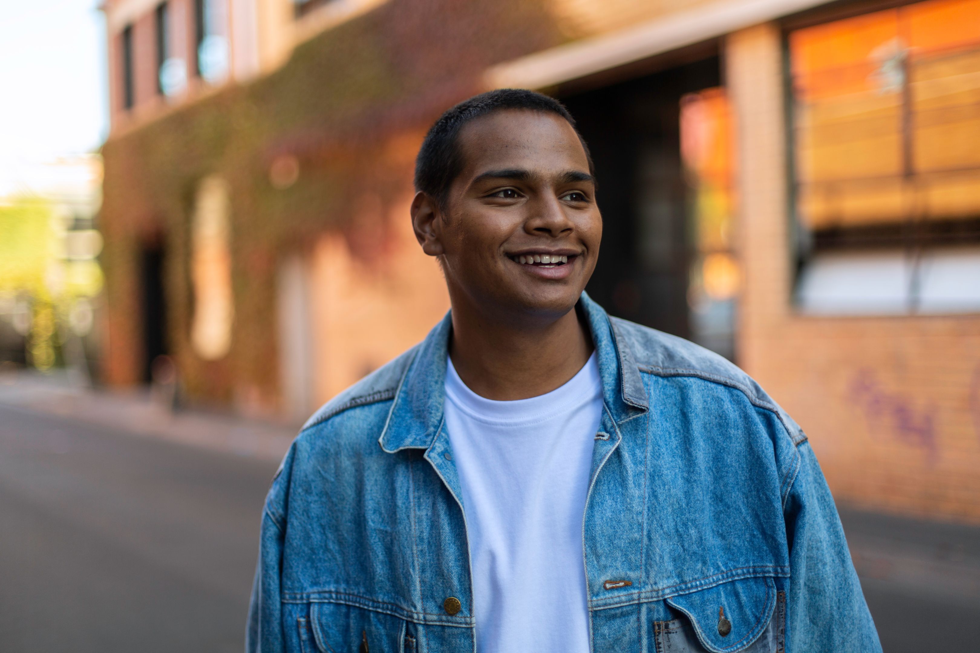 Swinburne student Joey, 20 years old, smiles confidently, looking towards the future. Guy looking off camera, as if into his bright future.