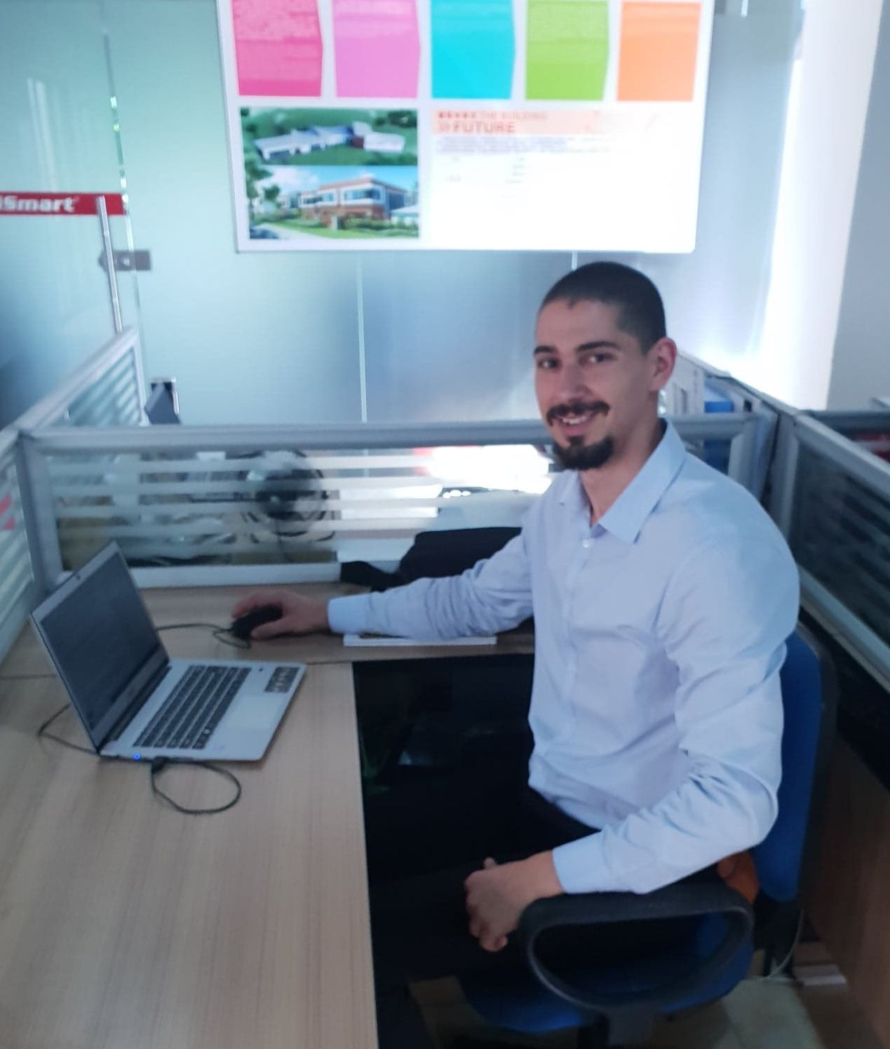 Study abroad and exchange student Damir Man sitting at a desk smiling at the camera