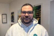 male student smiles at camera 