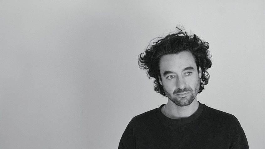 Kieran | Bachelor of Design(Industrial Design)(Honours) student A black and white headshot of Kieran, in a black t-shirt and gazing off camera.