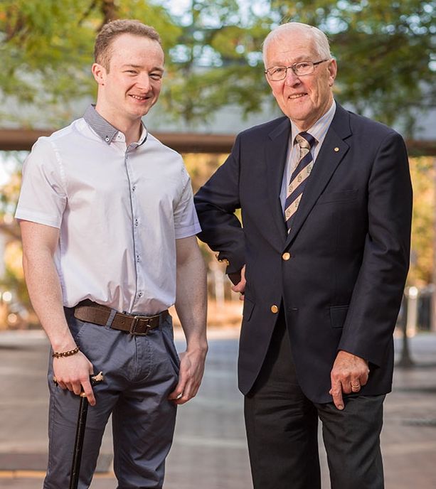Matt Ward and Keith Irvine OAM Matt Ward stands aided by cane to the left of Keith Irvine in suit attire