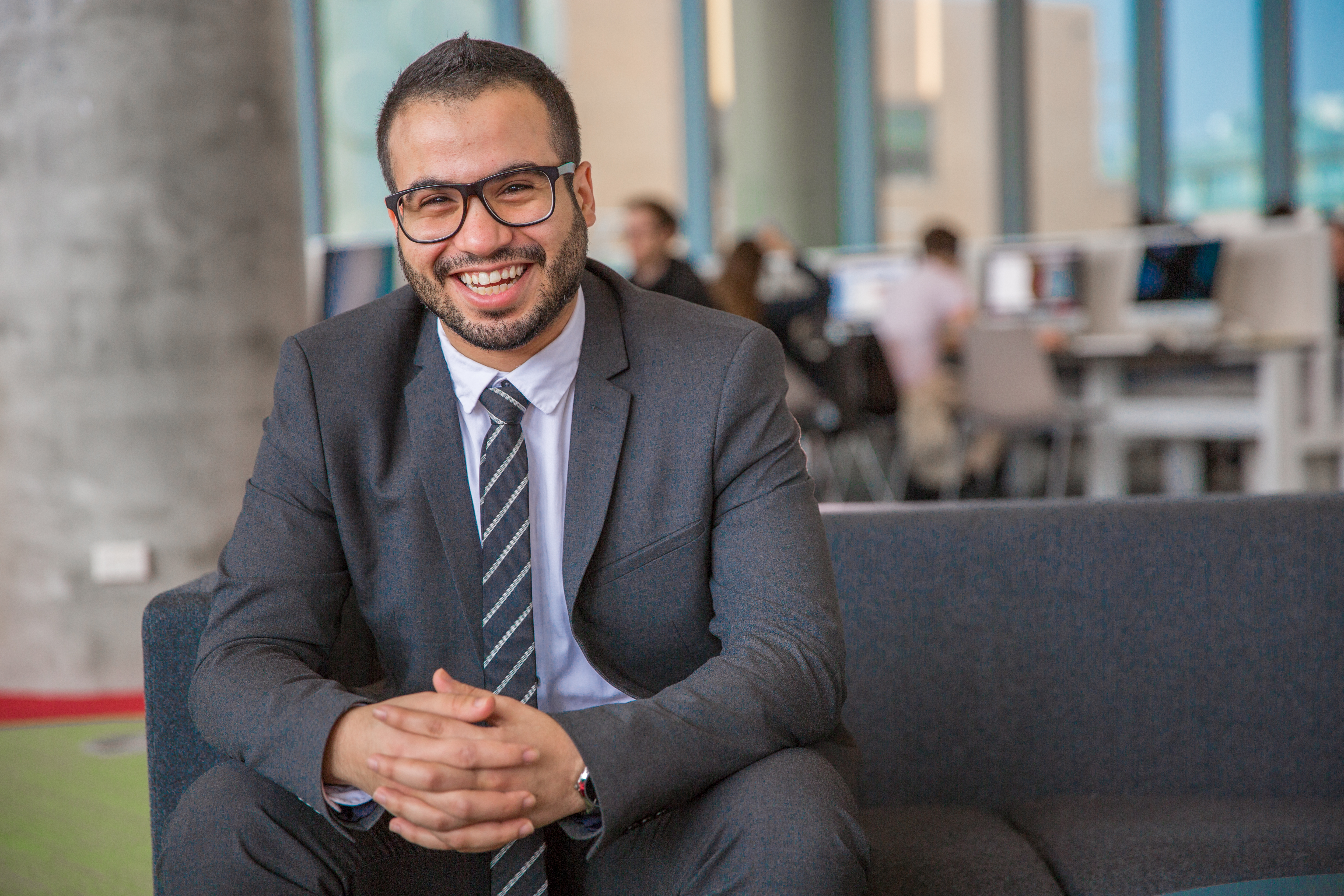 Mohammad, Student testimonial IT postgraduate Male IT student sits and smiles to the camera wearing glasses and dressed professionally