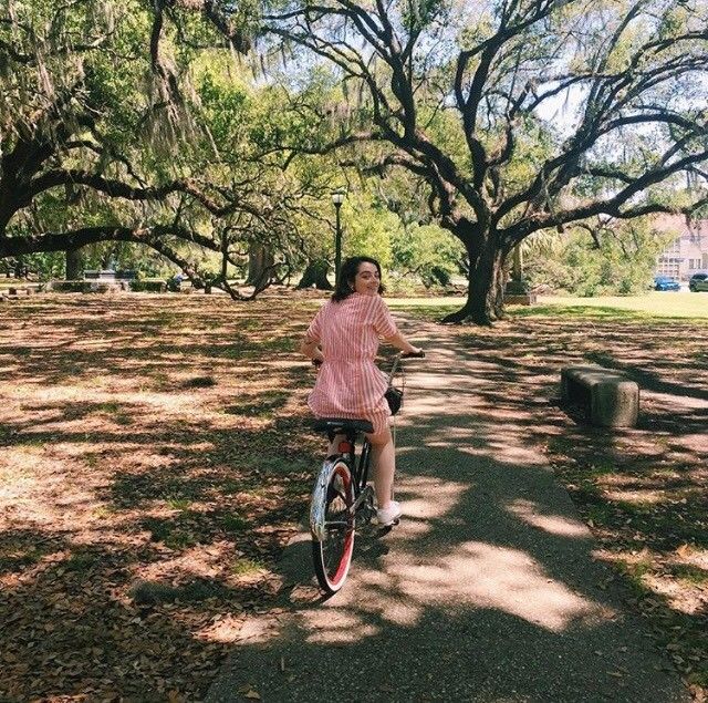 Yazmine Woman riding a bike through a park
