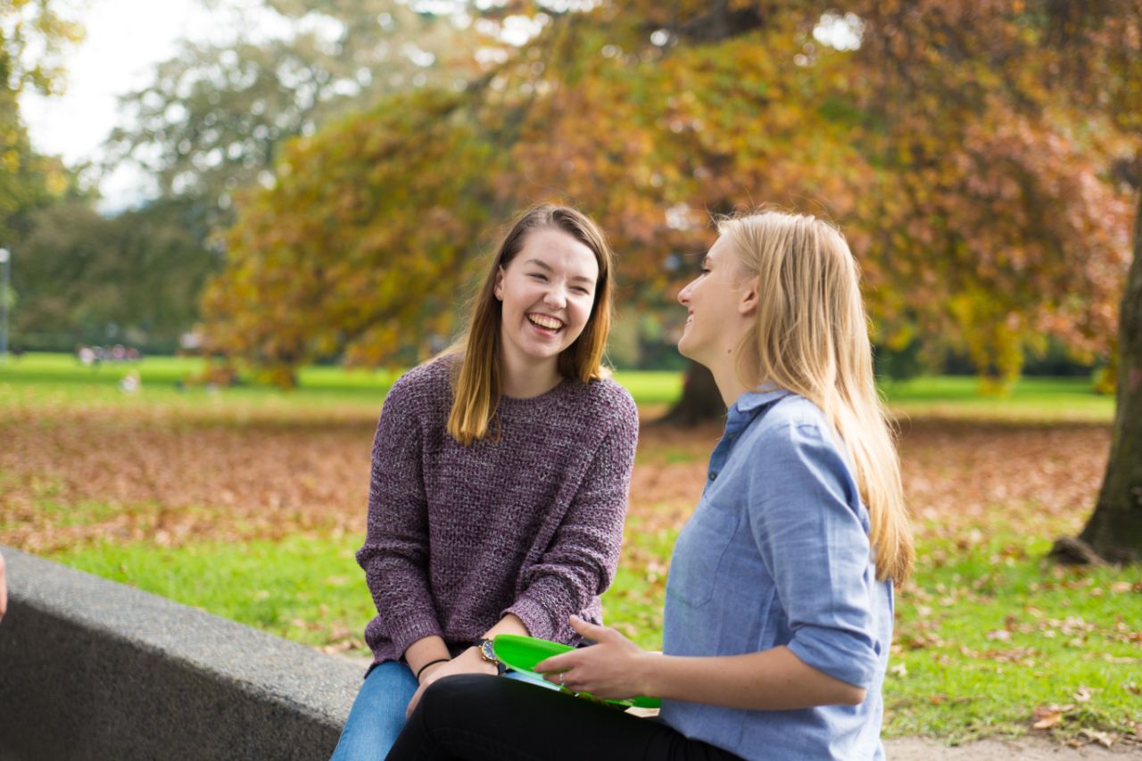 Students socialising in Central Gardens Two students socialising in the park with a frisbee