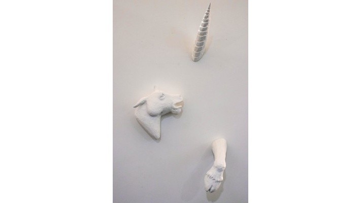 Sculptural wall installation featuring abstract white forms on display.