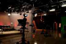 Photograph of a TV production set showing a couch and coffee table